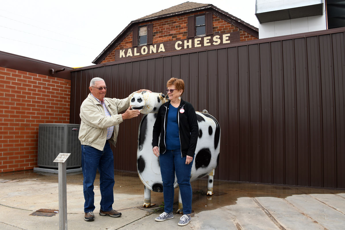 108 Don and Donna Regier pose with the dairy cow at the Kalona Cheese Factory.JPG